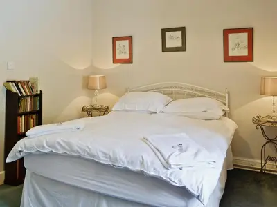 a bed with white sheets and towels on it at Crogen Wing in Llandrillo