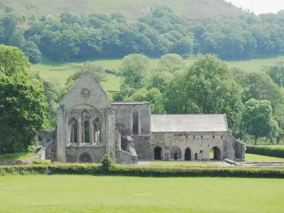 an old stone church in the middle of a field at Crogen Wing in Llandrillo
