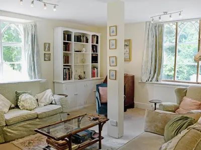 a living room with a couch and a table at Crogen Wing in Llandrillo