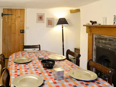 a table with plates and a pot on top of it at Hen Hafod in Llanfor