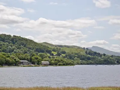 a view of a lake with mountains in the background at Maesmor in Bala