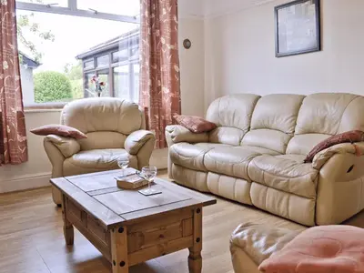 a living room with two couches and a coffee table at Maesmor in Bala
