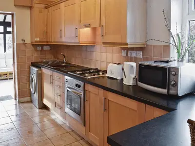 a kitchen with a stove and a microwave at Maesmor in Bala