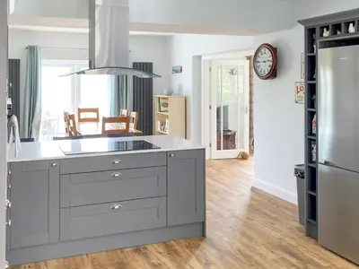 a kitchen with a large gray island in a kitchen at Cae-Fadog Fach in Barmouth
