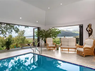 a house with a swimming pool with a view at Treetops in Fairbourne