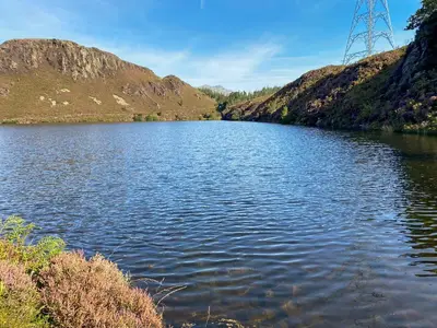 a body of water in front of a mountain at The Barn in Talsarnau