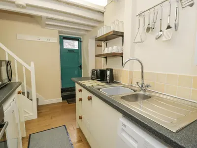 a kitchen with a sink and a counter top at 5 Tai Isa in Barmouth