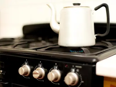 a white tea kettle sitting on top of a stove at YHA Brecon Beacons in Brecon