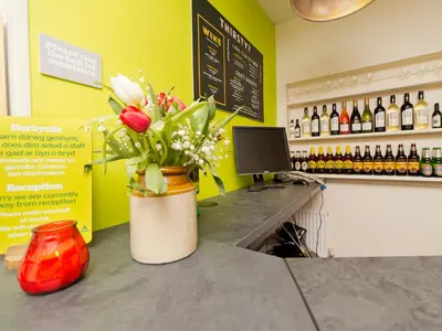 a counter with a vase of flowers on it at YHA Brecon Beacons in Brecon