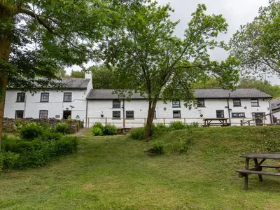 a white building with a picnic table in front of it at YHA Brecon Beacons in Brecon