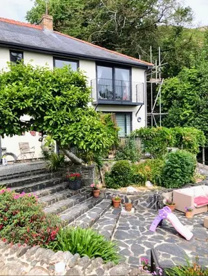 a house with a garden with a doll on the ground at Bryn Mynach Guest House in Barmouth