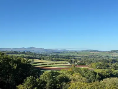 a view of a valley with trees and mountains at The Cottage at Sychnant Farm in Talgarth
