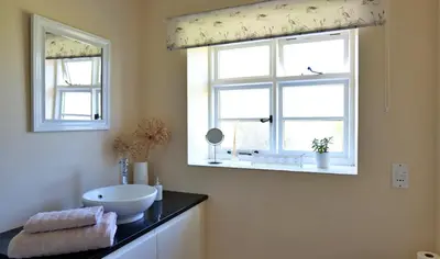 a bathroom with a sink and a window at Country Cottage with Far Reaching Views in Presteigne