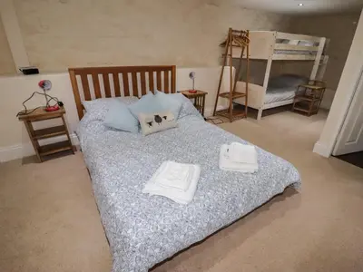 a bedroom with a bed with towels on it at Chapel House in Llangollen
