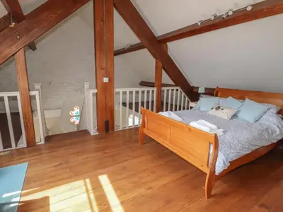 a bedroom with a bed in a attic at Chapel House in Llangollen