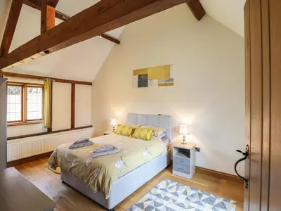 a bedroom with a bed in a room at Ysgubor Fachwen in Newtown