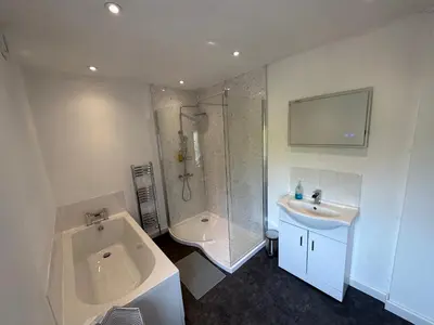 a bathroom with a tub and a sink and a shower at Newtown Townhouse in Newtown