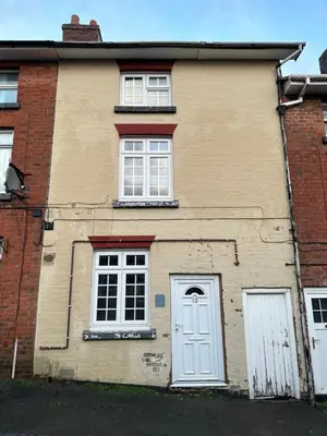 a brick house with a white door and windows at Newtown Townhouse in Newtown