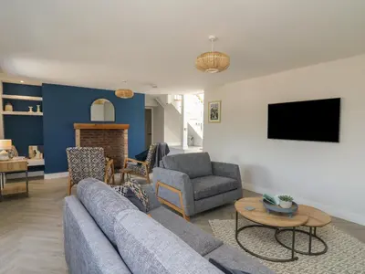 a living room with a couch and a tv at Rhiwmynach in Aberystwyth
