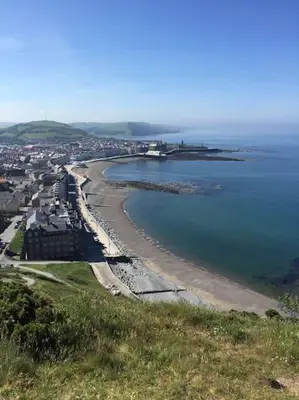 a view of a beach with houses and the ocean at Sunny View in Aberystwyth