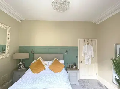 a bedroom with a bed and a robe hanging on the wall at Sunny View in Aberystwyth