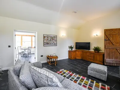 a living room with a couch and a television at Orchard View in Minsterley