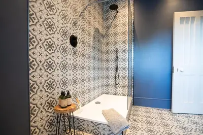 a bathroom with a shower with a tub at Llanerchydol Hall Suites in Welshpool