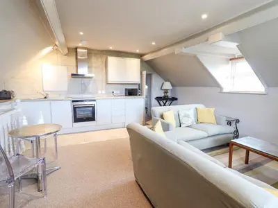 a living room with a couch and a table at Rock House Apartment in Newtown