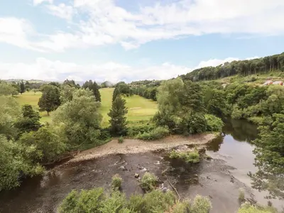 an aerial view of a river and trees at Rock House Apartment in Newtown