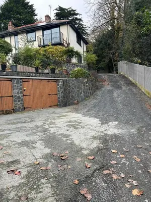 a driveway in front of a house with a fence at Bryn Mynach Annex in Barmouth