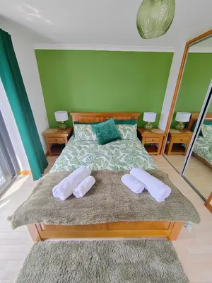 a bedroom with a bed with two towels on it at Bryn Mynach Annex in Barmouth