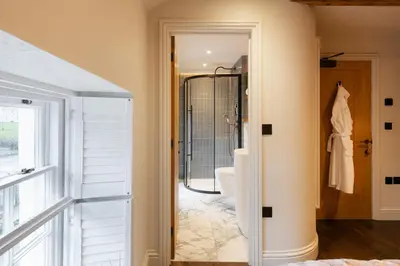 a bathroom with a shower and a toilet in a room at Hive Townhouse in Aberaeron