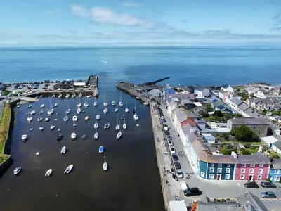 an aerial view of a harbor with boats in the water at Hive Townhouse in Aberaeron