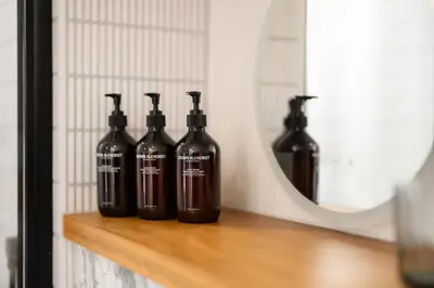 four bottles sitting on a shelf in front of a mirror at Hive Townhouse in Aberaeron