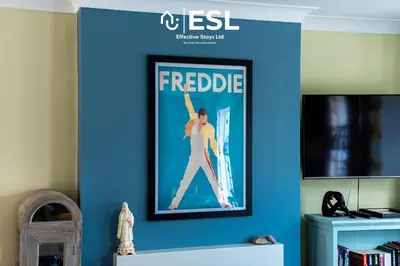 a framed picture of a woman on a blue wall at 4 Bedroom Townhouse 10mins walk from Shrewsbury Town Centre with Parking in Shrewsbury