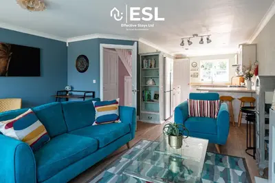 a blue living room with a blue couch and chairs at 4 Bedroom Townhouse 10mins walk from Shrewsbury Town Centre with Parking in Shrewsbury