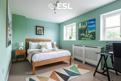 a bedroom with blue walls and a bed at 4 Bedroom Townhouse 10mins walk from Shrewsbury Town Centre with Parking in Shrewsbury