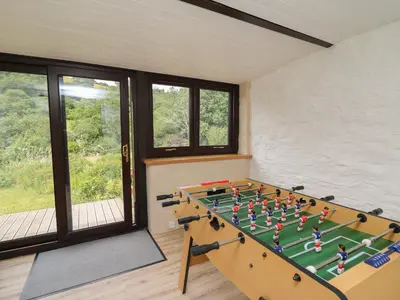 a foosball table in a room with windows at Penarth in Llandrindod Wells