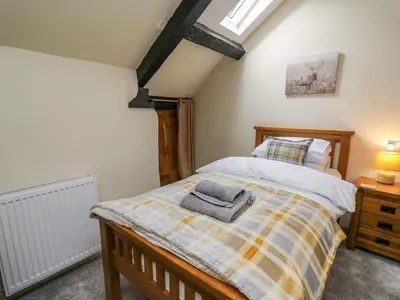 a bedroom with a bed with a towel on it at Penarth in Llandrindod Wells