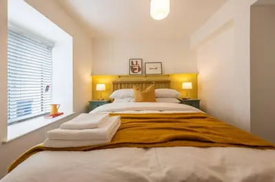a bedroom with a large bed with towels on it at Stylish, comfortable, convenient! in Bala