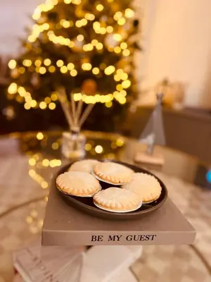 two cookies on a plate on a table with a christmas tree at Stylish, comfortable, convenient! in Bala