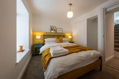 a bedroom with two beds with towels on it at Stylish, comfortable, convenient! in Bala