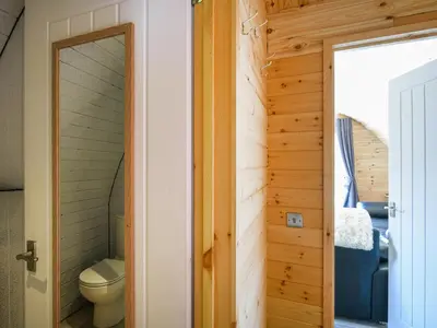 a door leading into a bathroom with a toilet at Barcud Coch - Uk44539 in Hirnant