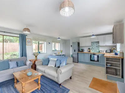 a living room with a couch and a table at High Bank in Pontesbury