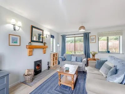 a living room with a couch and a fireplace at High Bank in Pontesbury