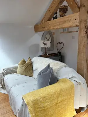 a bed with pillows on it in a room at The Hayloft in Hereford