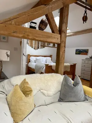 a room with a bed with pillows on it at The Hayloft in Hereford