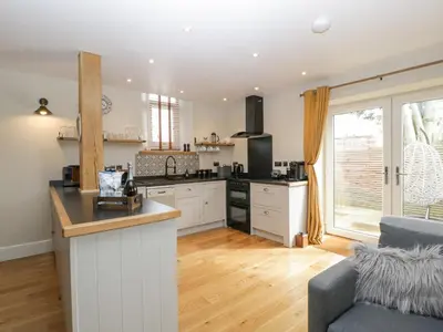a kitchen with white cabinets and a counter top at The Old Chapel in Hereford