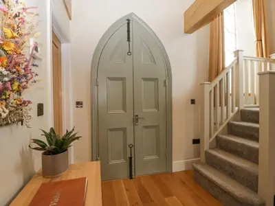 a hallway with a green door in a house at The Old Chapel in Hereford