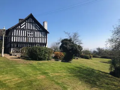 an old black and white building in a field at Rhydspence in Hay-on-Wye